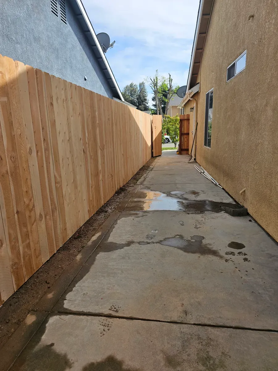 Tall fence along a concrete walkway in Fresno, California