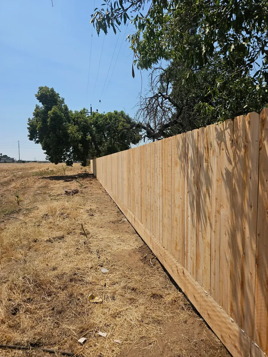 Long wood fence along a property line in Fresno, California